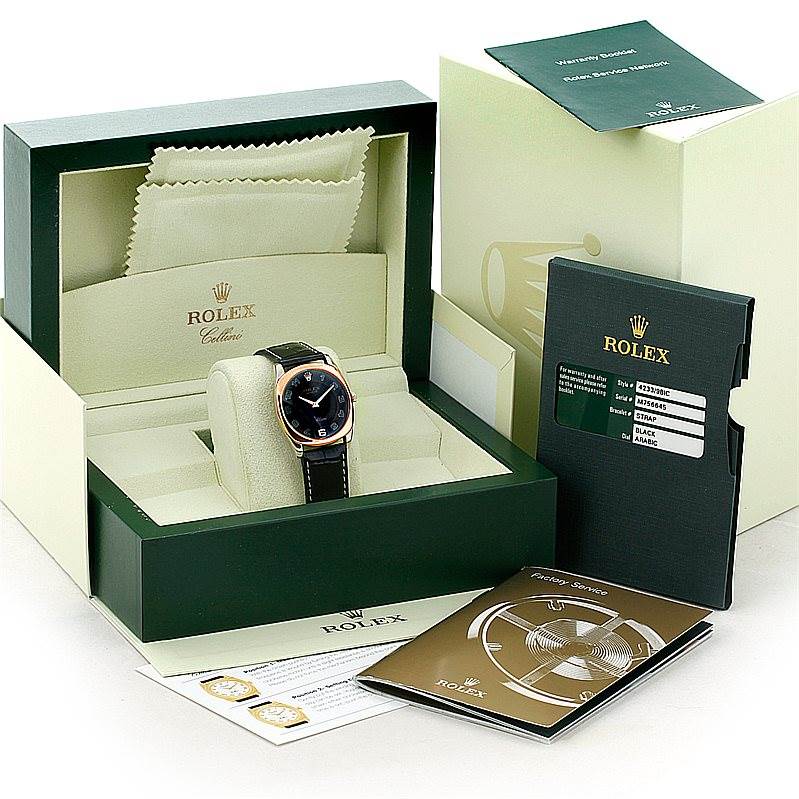 The image shows a Rolex Cellini 4233 Men's White Gold Black Dial 4233 Men's White Gold Black Dial watch in its box, with booklets, tags, and a cleaning cloth at a slightly elevated frontal angle.