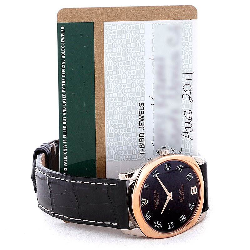 The image shows a Rolex Cellini 4233 Men's White Gold Black Dial 4233 Men's White Gold Black Dial watch from a side angle, highlighting the face, crown, and leather strap, with a warranty card behind it.