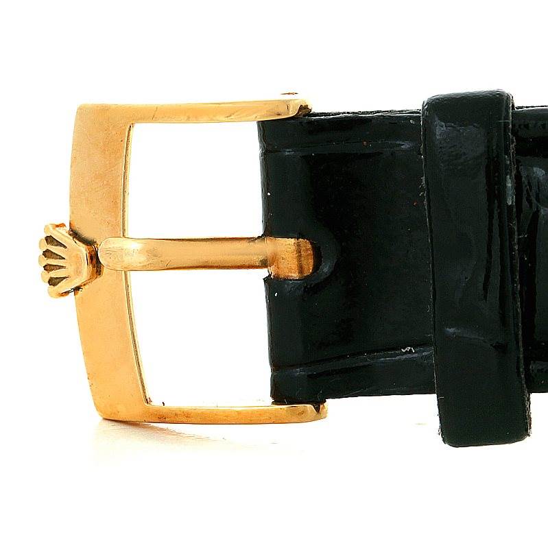 The image shows a close-up of the gold buckle and black leather strap of a Rolex Cellini 5116 Men's Yellow Gold Silver Dial 5116 Men's Yellow Gold Silver Dial watch.