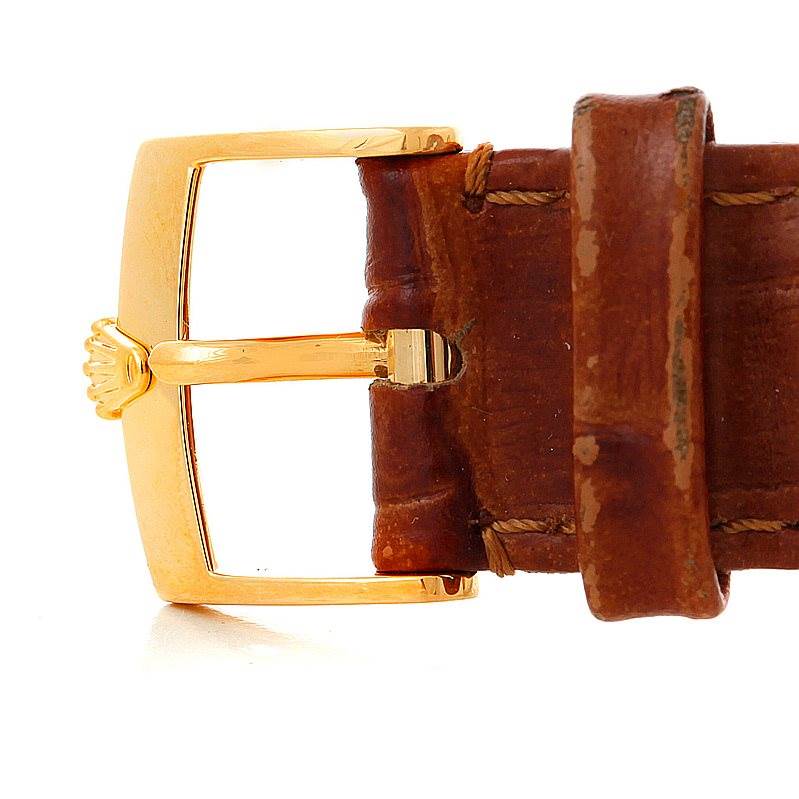 This image shows a close-up of the buckle and part of the leather strap of a Rolex Cellini 5115 Men's Yellow Gold Grey Dial 5115 Men's Yellow Gold Grey Dial watch.