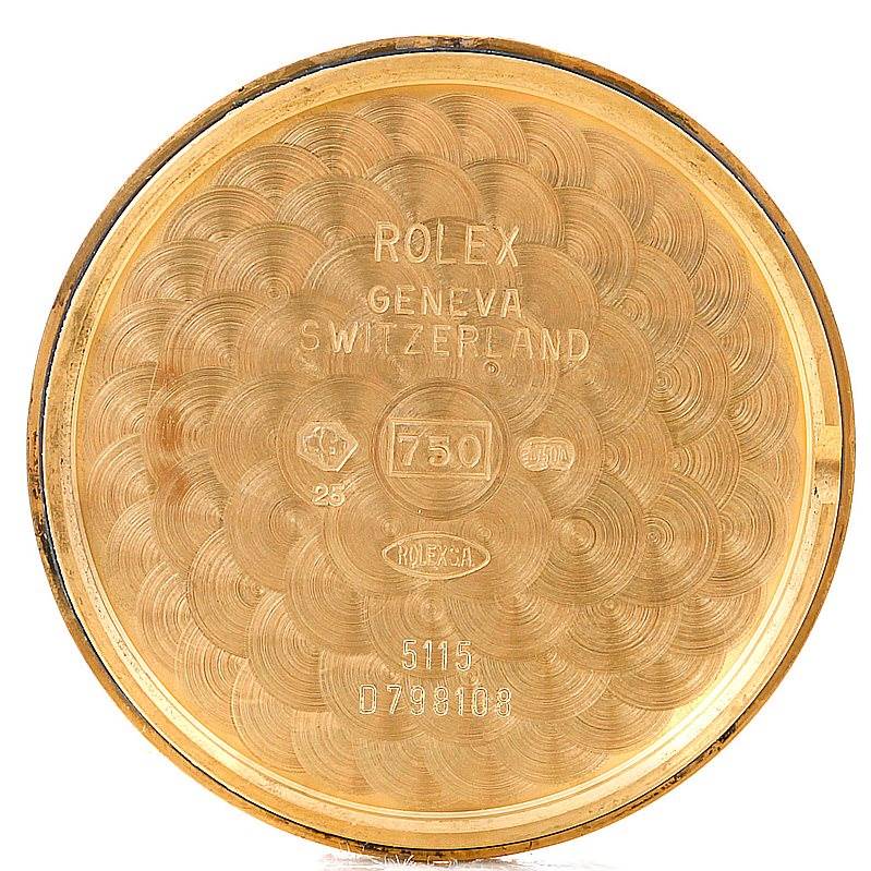 This image shows the interior case back of a Rolex Cellini 5115 Men's Yellow Gold Grey Dial 5115 Men's Yellow Gold Grey Dial watch, featuring engravings and stamps.