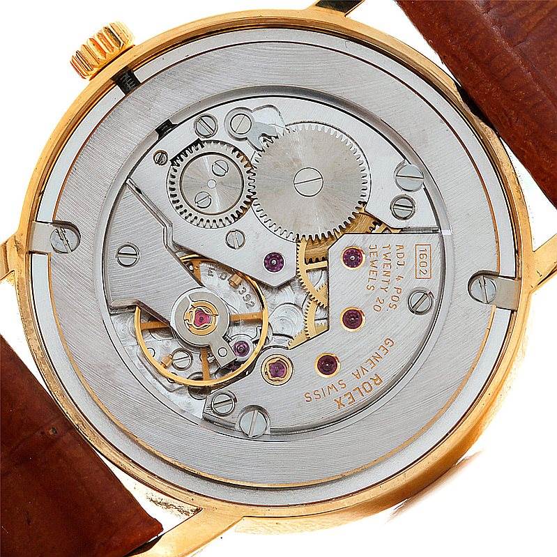 This image shows the movement of the Rolex Cellini 5115 Men's Yellow Gold Grey Dial 5115 Men's Yellow Gold Grey Dial watch from the back, highlighting its intricate gears and components.