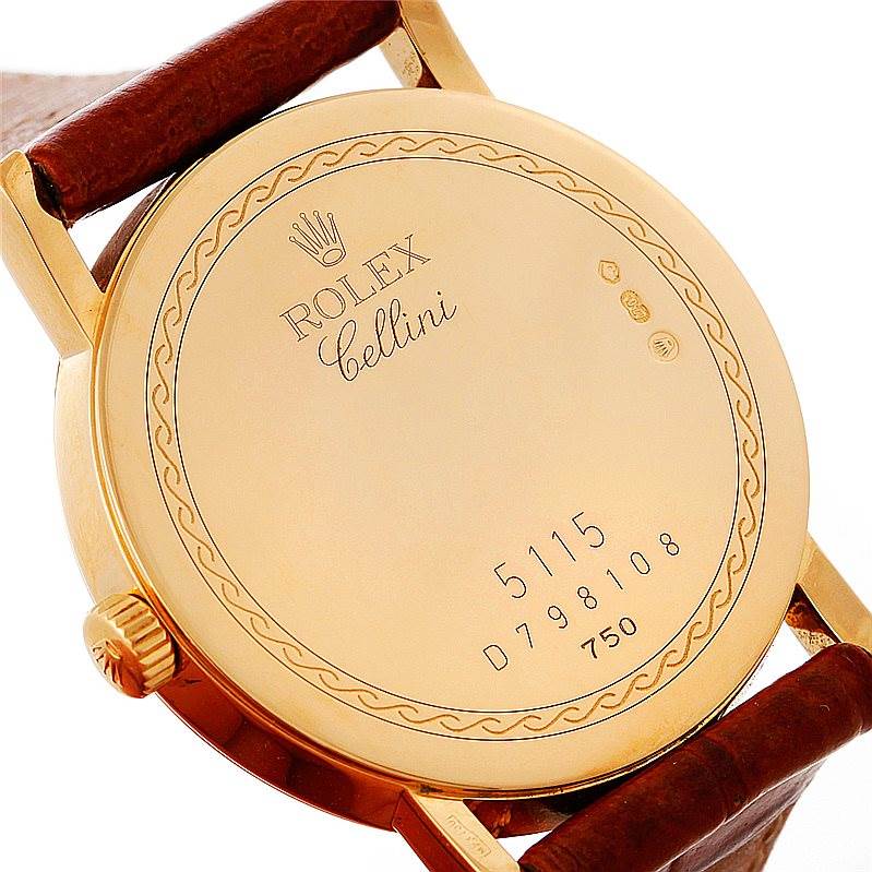 The image shows the back case of a Rolex Cellini 5115 Men's Yellow Gold Grey Dial 5115 Men's Yellow Gold Grey Dial watch, focusing on its engraved details and leather strap attachment points.