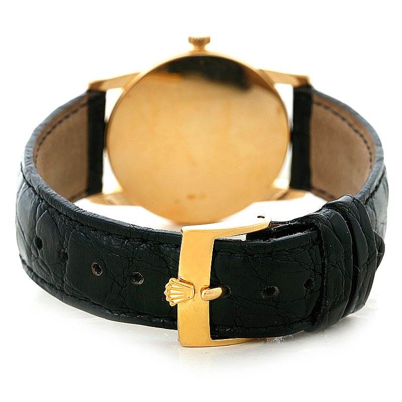 The image shows the back of the Rolex Cellini 5116 Men's Yellow Gold Mother of Pearl Dial 5116 Men's Yellow Gold Mother of Pearl Dial watch, focusing on its black leather strap and gold buckle.