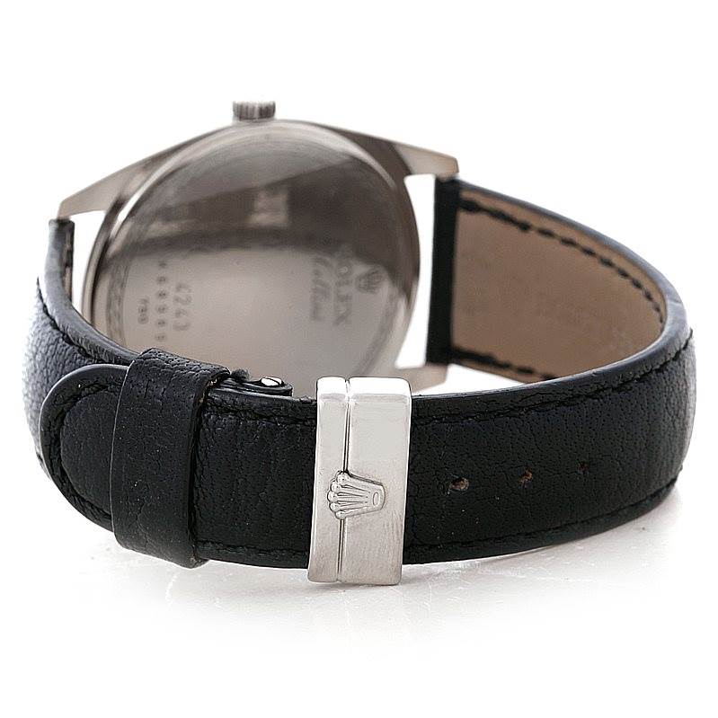 The image shows the back of a Rolex Cellini 4243 Men's White Gold Black Dial 4243 Men's White Gold Black Dial watch, highlighting the case back and black leather strap with a clasp.