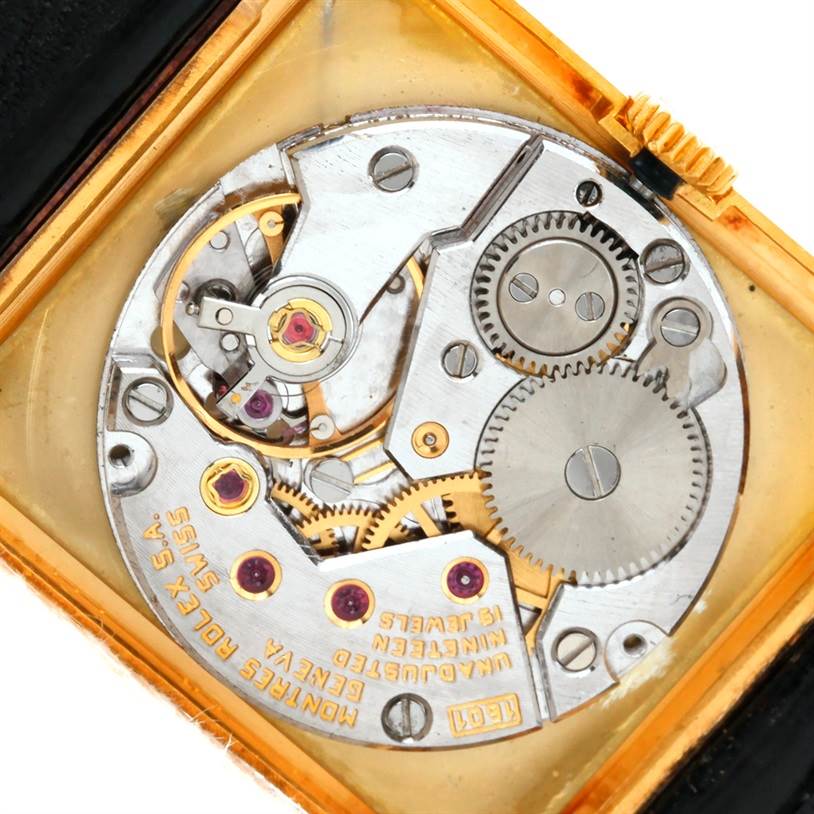 The image shows the internal mechanical movement of a Rolex Cellini 4127 Men
s Yellow Gold Champagne Dial 4127 Men
s Yellow Gold Champagne Dial watch, with gears, jewels, and inscriptions visible.