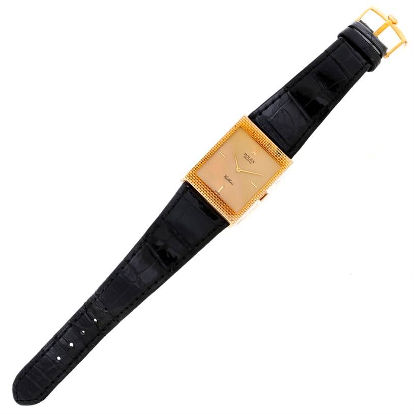 The image shows a top view of a Rolex Cellini 4127 Men
s Yellow Gold Champagne Dial 4127 Men
s Yellow Gold Champagne Dial watch, displaying its gold rectangular face and black leather strap.