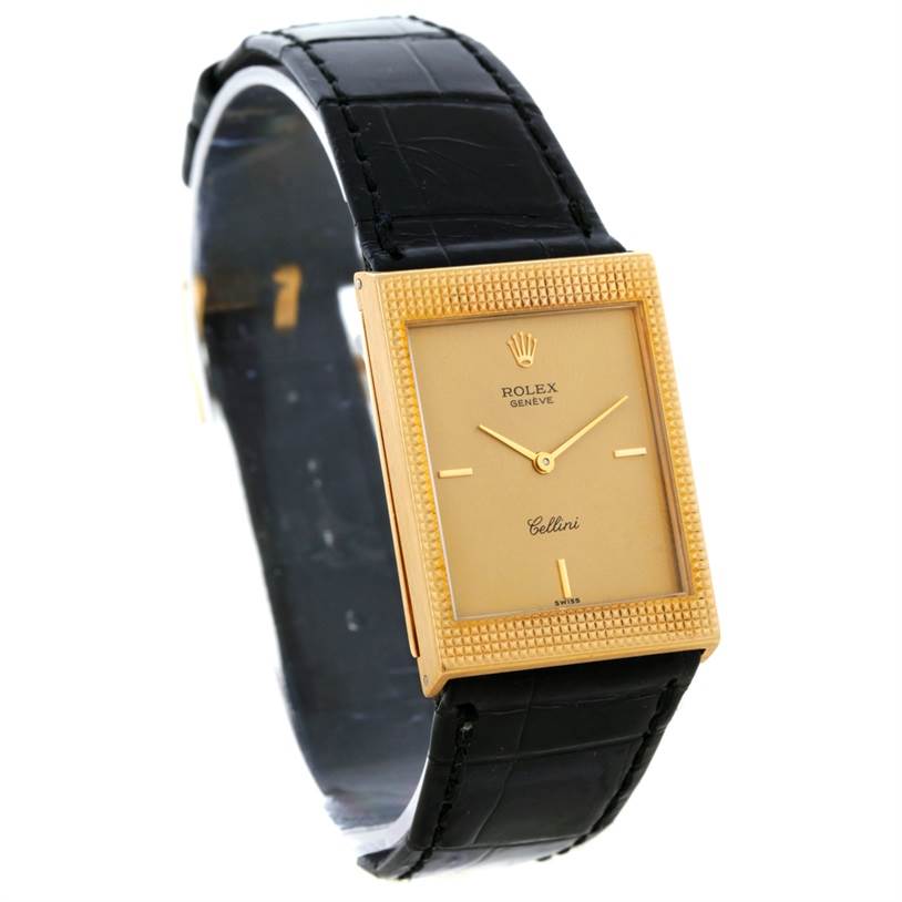 The Rolex Cellini 4127 Men
s Yellow Gold Champagne Dial 4127 Men
s Yellow Gold Champagne Dial watch is shown at a three-quarter angle highlighting its gold rectangular case and black leather strap.