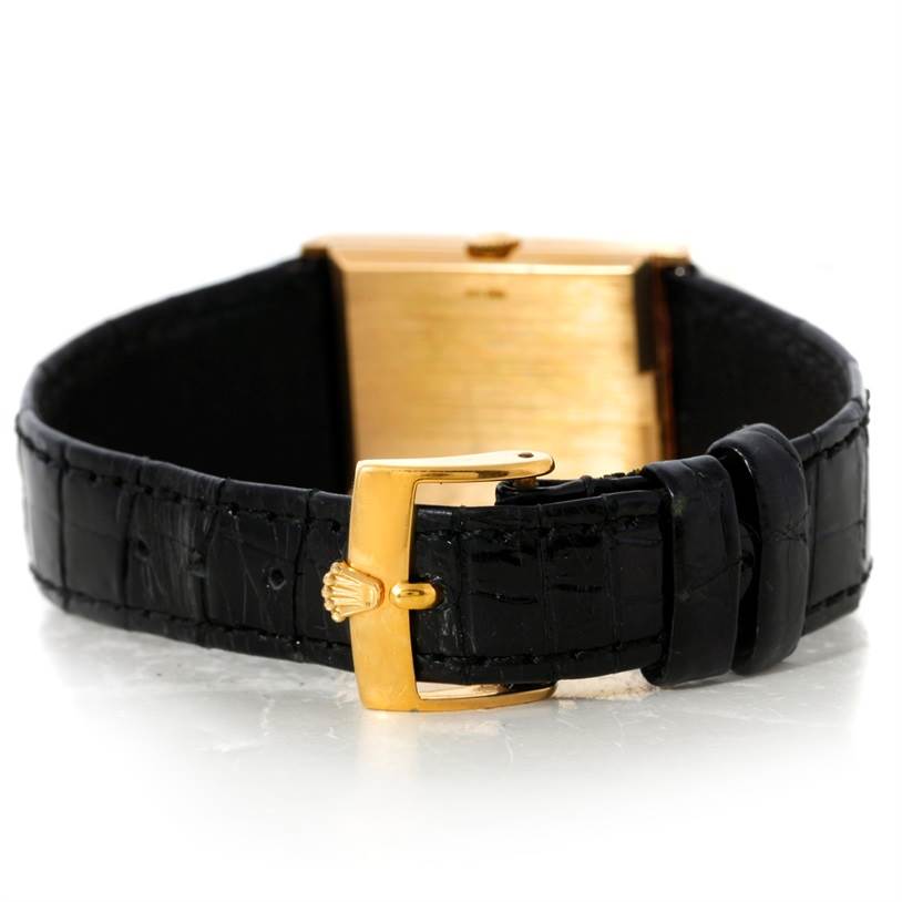 This image shows the back view of a Rolex Cellini 4127 Men
s Yellow Gold Champagne Dial 4127 Men
s Yellow Gold Champagne Dial watch, highlighting its black strap and gold buckle.