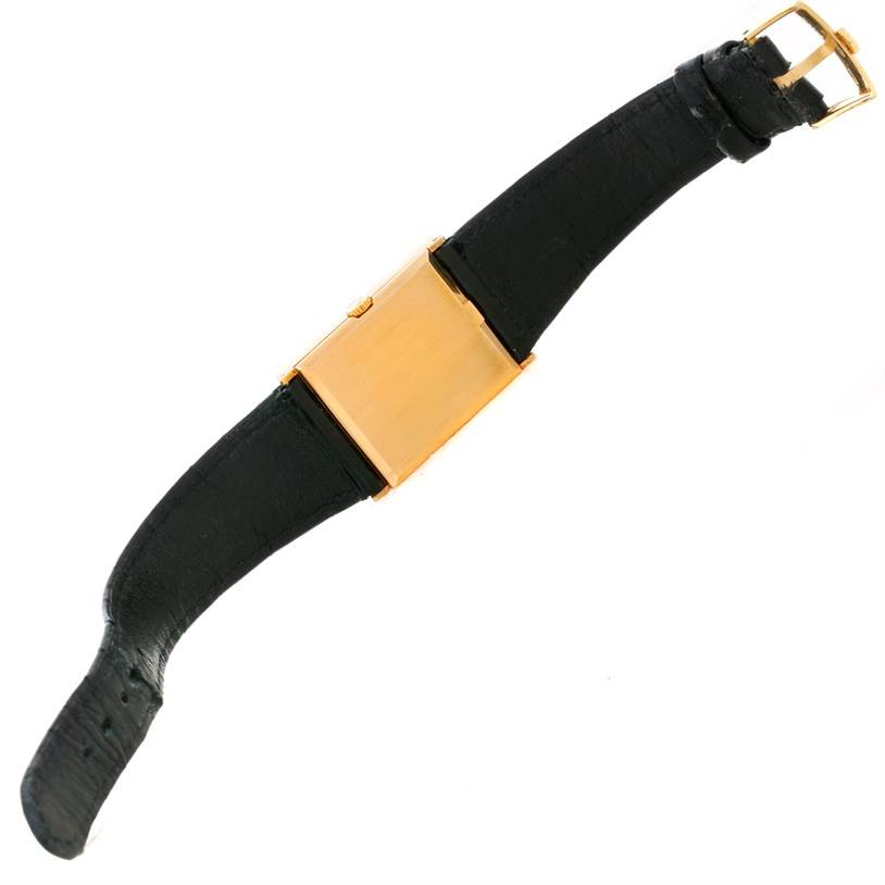 This image shows a side angle of a Rolex Cellini 4127 Men
s Yellow Gold Champagne Dial 4127 Men
s Yellow Gold Champagne Dial watch, highlighting its black strap and gold case and buckle.