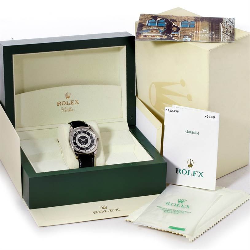 The image shows the Rolex Cellini 4243 Men's White Gold Black Dial 4243 Men's White Gold Black Dial watch with its original packaging, warranty card, and informational booklets from a front angle.