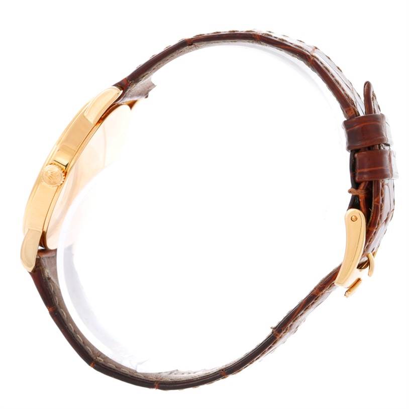 The Rolex Cellini 5115 Men's Yellow Gold Mother of Pearl Dial 5115 Men's Yellow Gold Mother of Pearl Dial watch is shown from a side angle, displaying the gold case and the brown leather strap with buckle.