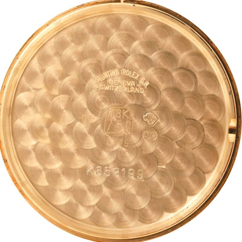 This image shows the inside back cover of a Rolex Cellini 5115 Men's Yellow Gold Mother of Pearl Dial 5115 Men's Yellow Gold Mother of Pearl Dial watch, displaying various engravings and stamps.