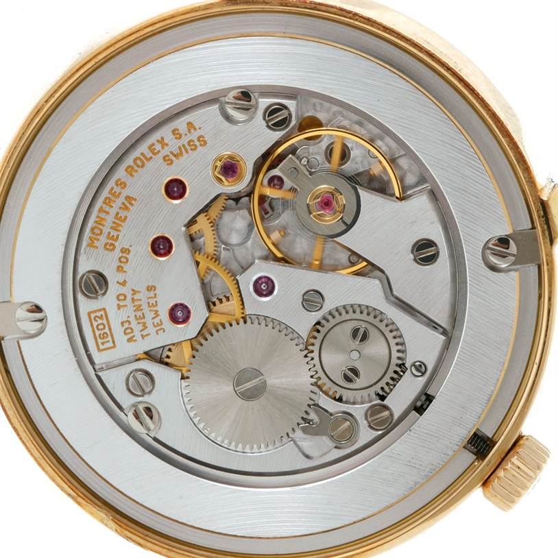 This image shows the movement of a Rolex Cellini 5115 Men's Yellow Gold Mother of Pearl Dial 5115 Men's Yellow Gold Mother of Pearl Dial watch, focusing on its intricate internal gears and components.