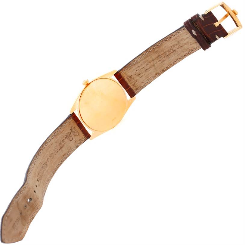 The image shows the back and strap of a Rolex Cellini 4233 Men's Yellow Gold Black Dial 4233 Men's Yellow Gold Black Dial watch, viewed from above.