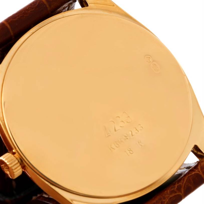The image shows the back case and crown of a Rolex Cellini 4233 Men's Yellow Gold Black Dial 4233 Men's Yellow Gold Black Dial watch with a leather strap.