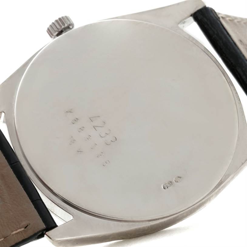 The image shows the back case and part of the strap of a Rolex Cellini 4233 Men's White Gold Black Dial 4233 Men's White Gold Black Dial watch.