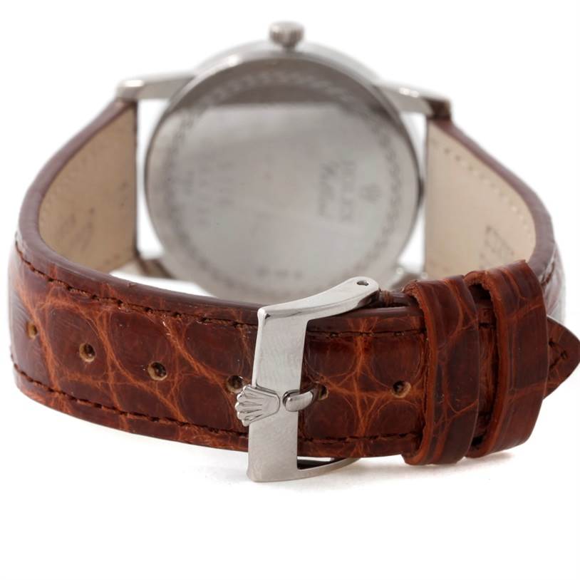 The image shows the back of a Rolex Cellini 5116 Men's White Gold Black Dial 5116 Men's White Gold Black Dial watch, focusing on its brown leather strap and silver buckle.