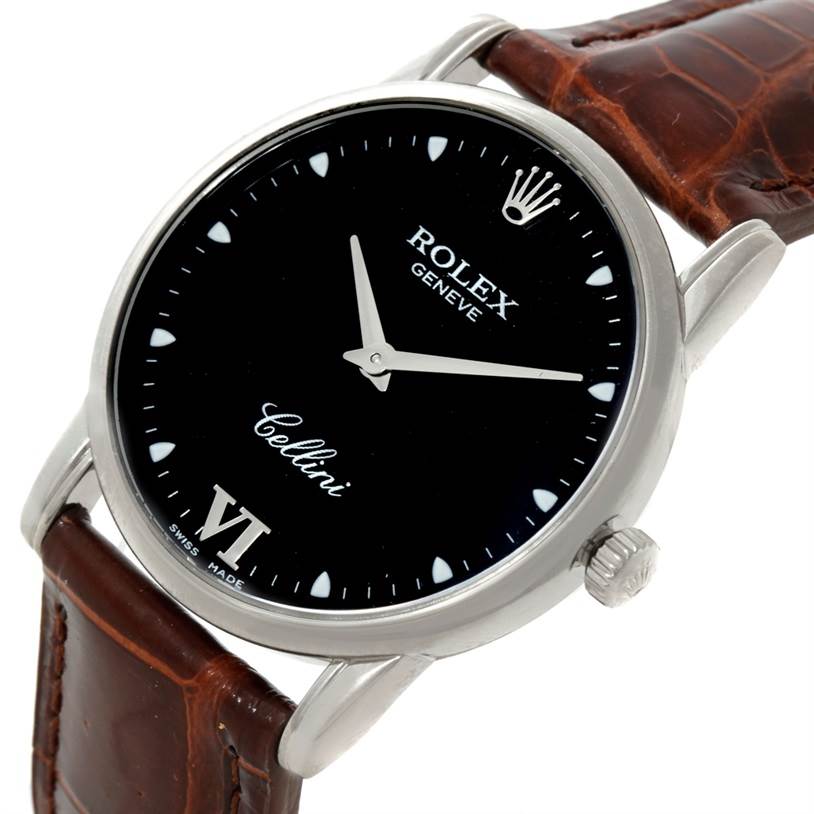 The image shows a tilted Rolex Cellini 5116 Men's White Gold Black Dial 5116 Men's White Gold Black Dial watch, highlighting its black dial, silver markers, and brown leather strap.