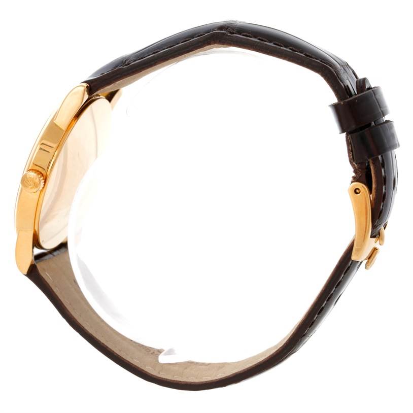 This image shows a side view of the Rolex Cellini 5116 Men's Yellow Gold Grey Dial 5116 Men's Yellow Gold Grey Dial watch, highlighting its gold casing, crown, and brown leather strap from the edge.