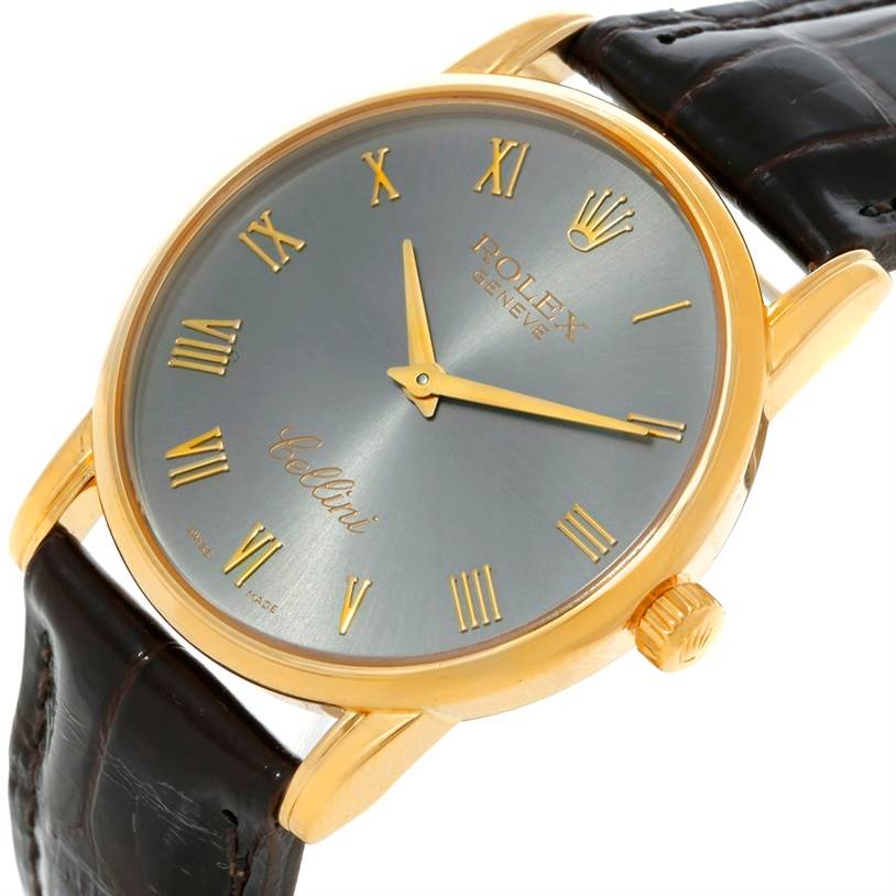 The image displays a Rolex Cellini 5116 Men's Yellow Gold Grey Dial 5116 Men's Yellow Gold Grey Dial watch at an angle, showing its face, crown, and leather strap.