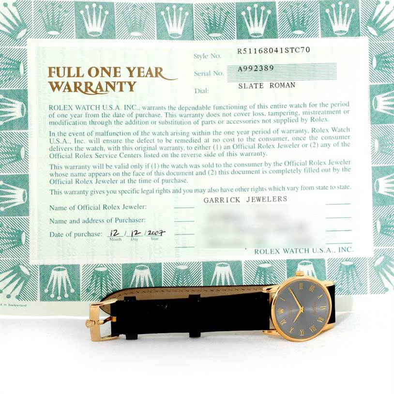 The image shows a Rolex Cellini 5116 Men's Yellow Gold Grey Dial 5116 Men's Yellow Gold Grey Dial watch and its warranty card, highlighting the watch face and band.