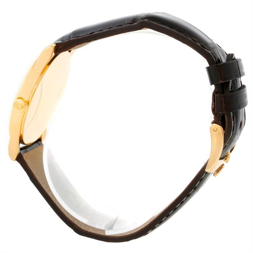 This image shows a side profile of a Rolex Cellini 5116 Men
s Yellow Gold Champagne Dial 5116 Men
s Yellow Gold Champagne Dial watch, highlighting its gold case and leather strap with a buckle.