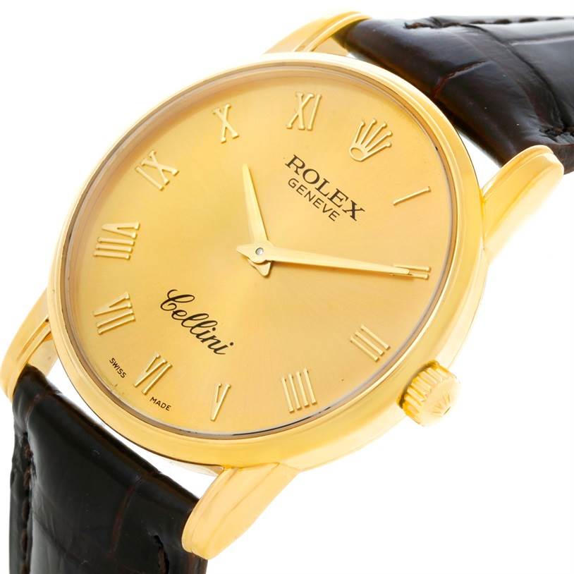 The Rolex Cellini 5116 Men
s Yellow Gold Champagne Dial 5116 Men
s Yellow Gold Champagne Dial watch is shown at an angled view, highlighting its dial, gold case, Roman numerals, crown, and leather strap.