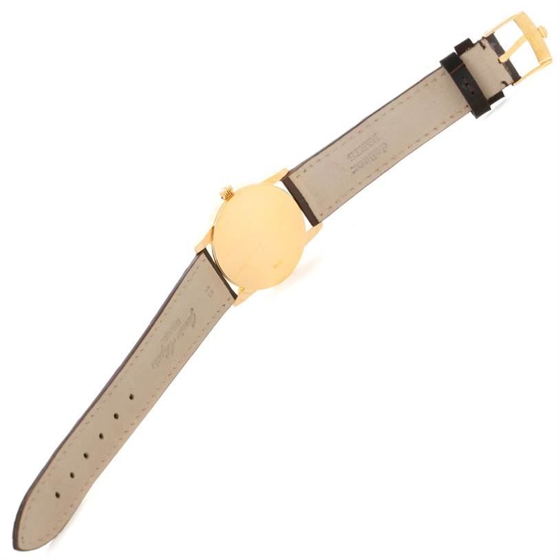 The image shows the back and strap of a Rolex Cellini 5116 Men
s Yellow Gold Champagne Dial 5116 Men
s Yellow Gold Champagne Dial model watch from an angled top-down perspective.