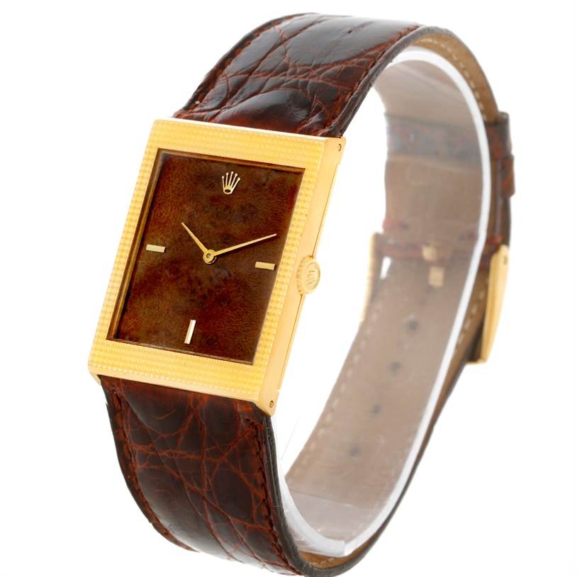 The image shows a Rolex Cellini 4127 Men's Yellow Gold Brown Dial 4127 Men's Yellow Gold Brown Dial watch from a three-quarter angle, highlighting its rectangular dial, gold case, and brown leather strap.