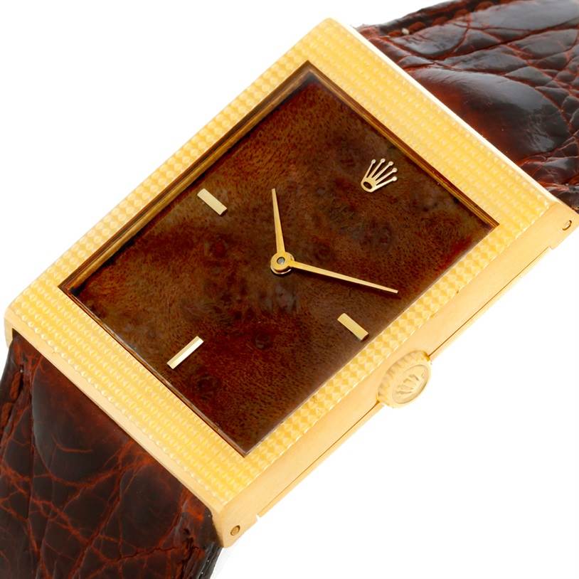 This is a close-up view of the Rolex Cellini 4127 Men's Yellow Gold Brown Dial 4127 Men's Yellow Gold Brown Dial watch, showing its rectangular face, gold case, and crown along with a brown leather strap.