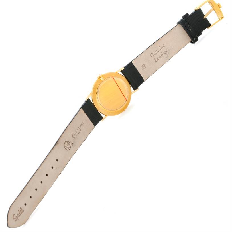 The image shows the underside view of a Rolex Cellini 3833 Men
s Yellow Gold Champagne Dial 3833 Men
s Yellow Gold Champagne Dial watch, displaying the leather strap and buckle.