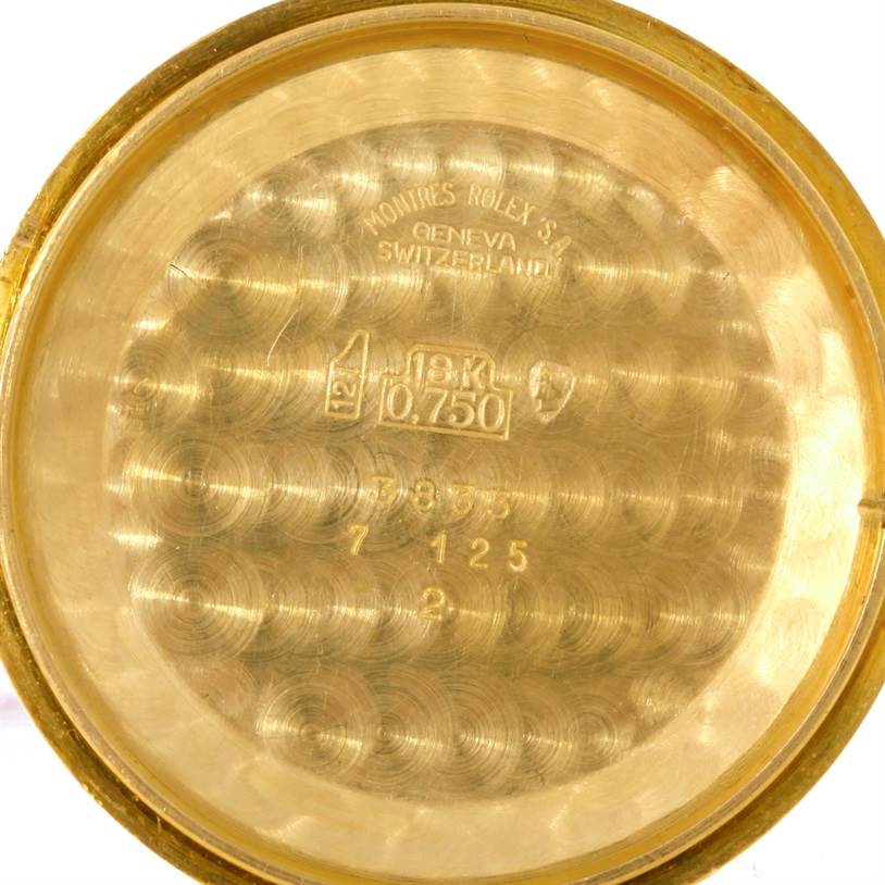 This image shows the inside of a gold case back for a Rolex Cellini 3833 Men
s Yellow Gold Champagne Dial 3833 Men
s Yellow Gold Champagne Dial watch, displaying engravings and hallmarks.