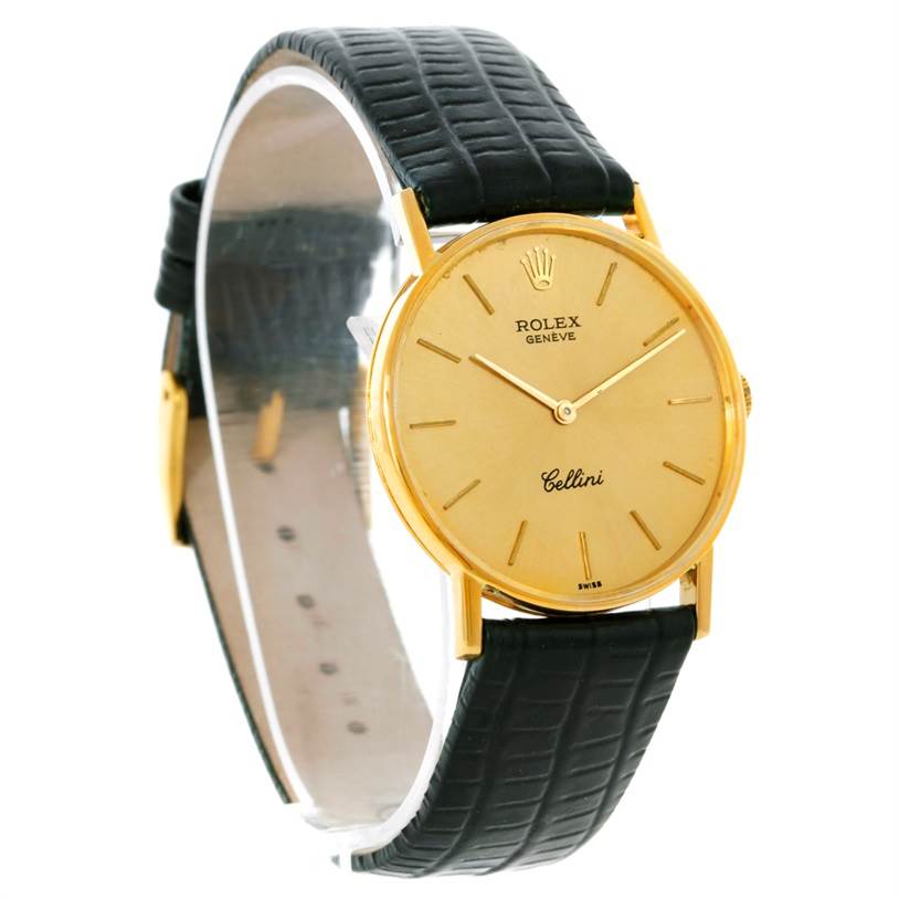 The Rolex Cellini 3833 Men
s Yellow Gold Champagne Dial 3833 Men
s Yellow Gold Champagne Dial watch is shown at a slight side angle, highlighting its gold dial, gold casing, and black leather strap.