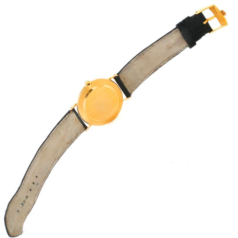 The image shows the back and the strap of a Rolex Cellini 4112 Men
s Yellow Gold Champagne Dial 4112 Men
s Yellow Gold Champagne Dial watch, displayed from a top-down angle.