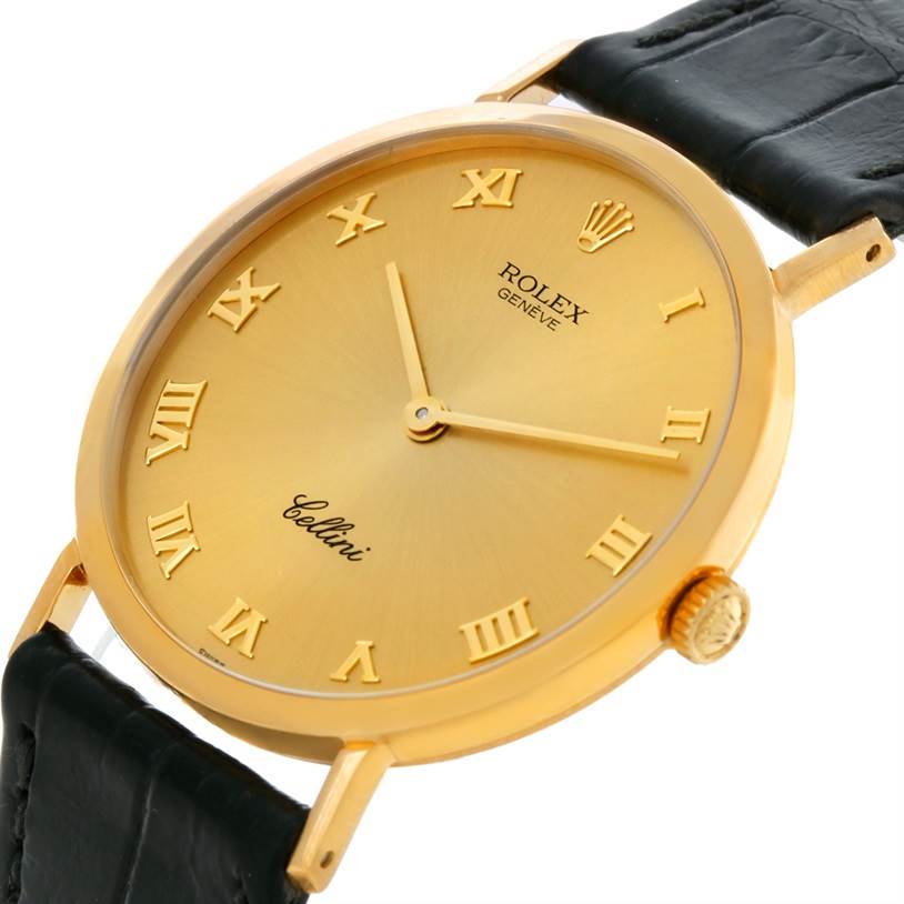 The image shows a close-up angle of the Rolex Cellini 4112 Men
s Yellow Gold Champagne Dial 4112 Men
s Yellow Gold Champagne Dial watch, highlighting the gold dial, case, crown, and part of the black leather strap.