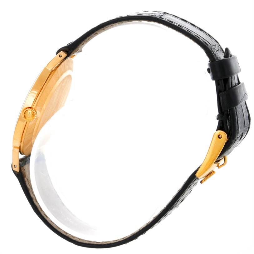 Side view of the Rolex Cellini 4112 Men
s Yellow Gold Champagne Dial 4112 Men
s Yellow Gold Champagne Dial watch displaying its gold case and black leather strap with buckle.