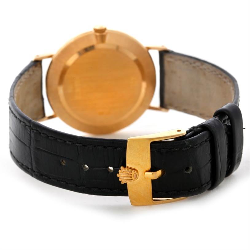 The image shows the back case and strap, including the buckle, of the Rolex Cellini 4112 Men
s Yellow Gold Champagne Dial 4112 Men
s Yellow Gold Champagne Dial watch from a rear angle.