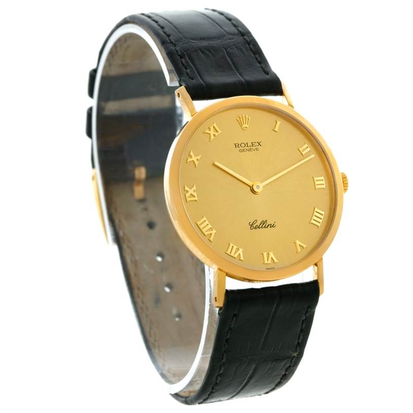 The Rolex Cellini 4112 Men
s Yellow Gold Champagne Dial 4112 Men
s Yellow Gold Champagne Dial watch is shown at a three-quarter angle, displaying the gold face, Roman numerals, and black leather strap.