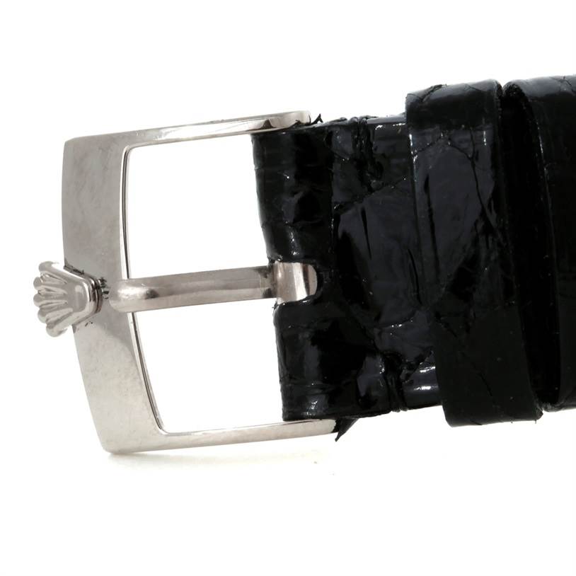 This image shows a close-up side view of the black leather strap and silver buckle of a Rolex Cellini 5116 Men's White Gold Silver Dial 5116 Men's White Gold Silver Dial watch.