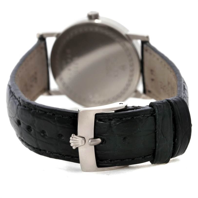 The image shows a Rolex Cellini 5116 Men's White Gold Silver Dial 5116 Men's White Gold Silver Dial watch from the rear, highlighting its strap and clasp with the Rolex emblem.