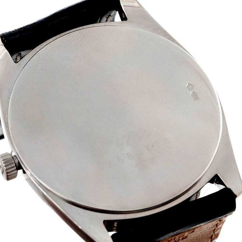 This image shows the back case and a portion of the strap of a Rolex Cellini 4233 Men's White Gold White Dial 4233 Men's White Gold White Dial watch.