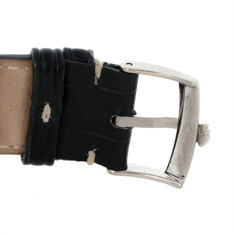 The image shows the clasp and a portion of the leather strap of a Rolex Cellini 4233 Men's White Gold White Dial 4233 Men's White Gold White Dial watch.