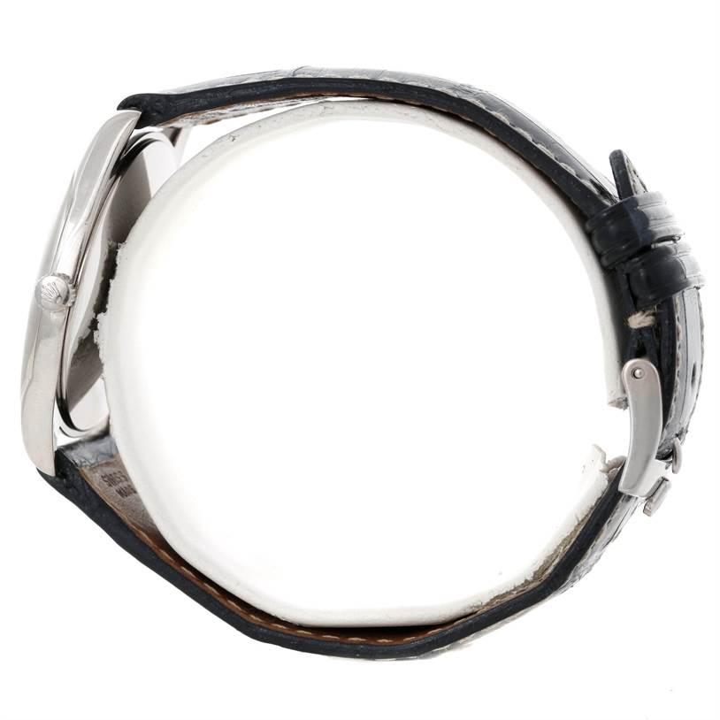 This side profile view of the Rolex Cellini 4233 Men's White Gold White Dial 4233 Men's White Gold White Dial watch features its case, crown, and leather strap with a buckle clasp.