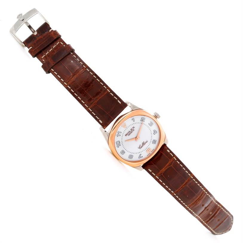 This image shows a Rolex Cellini 4233 Men's White Gold White Dial 4233 Men's White Gold White Dial watch laid flat, showcasing its face, leather strap, and buckle.