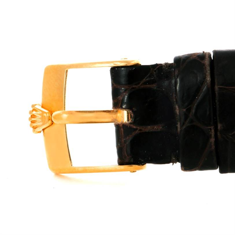 The image shows a side view of the clasp and part of the leather strap of a Rolex Cellini 4112 Men
s Yellow Gold Champagne Dial 4112 Men
s Yellow Gold Champagne Dial watch.