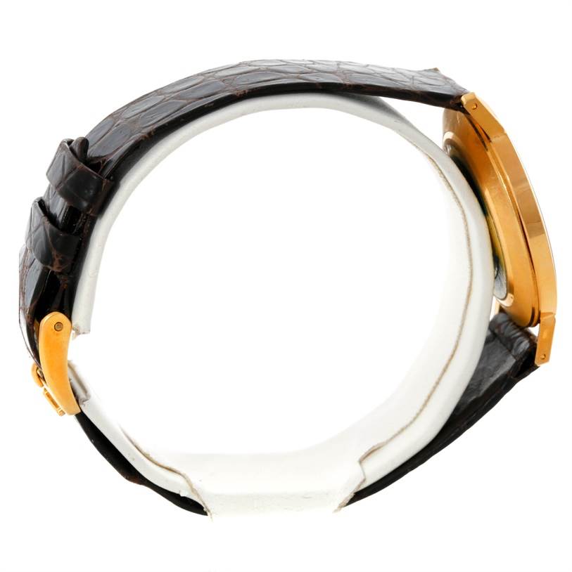 This side view of the Rolex Cellini 4112 Men
s Yellow Gold Champagne Dial 4112 Men
s Yellow Gold Champagne Dial watch shows the strap and gold case, showcasing its profile.