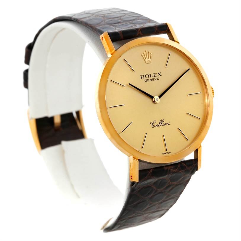 This image shows an angled view of a Rolex Cellini 4112 Men
s Yellow Gold Champagne Dial 4112 Men
s Yellow Gold Champagne Dial watch, highlighting its gold case, dial, and leather strap.