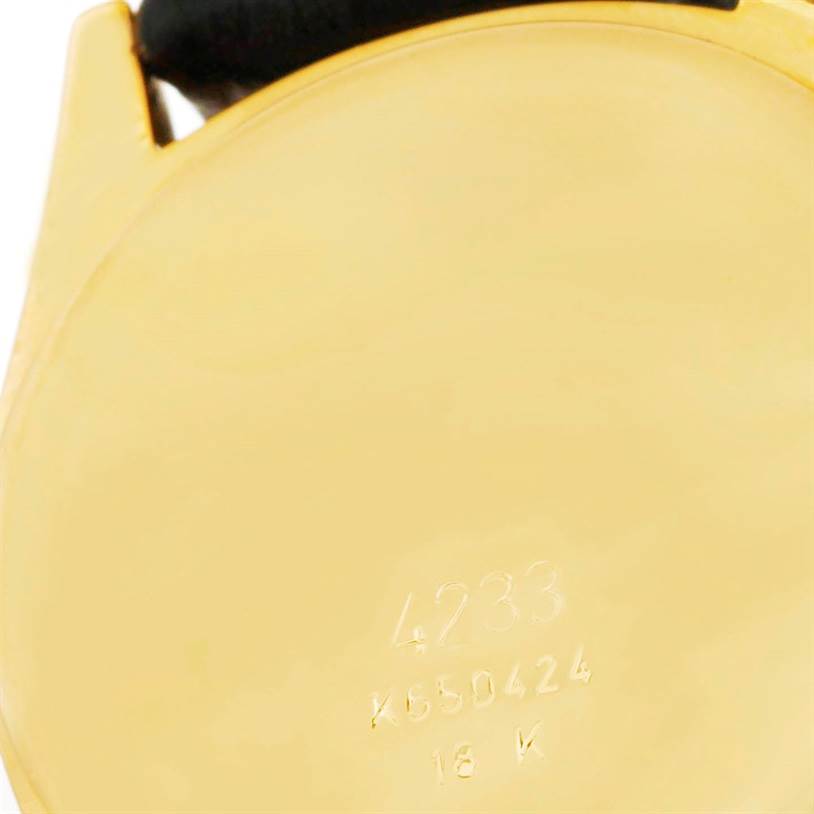 The image shows the engraved back of a Rolex Cellini 4233 Men's Yellow Gold Black Dial 4233 Men's Yellow Gold Black Dial watch, displaying model number and 18K gold marking.