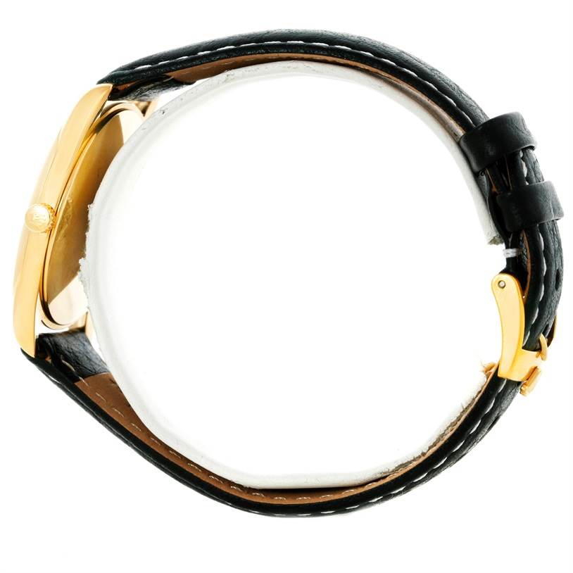 This image shows a side view of a Rolex Cellini 4233 Men's Yellow Gold Black Dial 4233 Men's Yellow Gold Black Dial watch, highlighting its gold case, black leather strap, and buckle clasp.